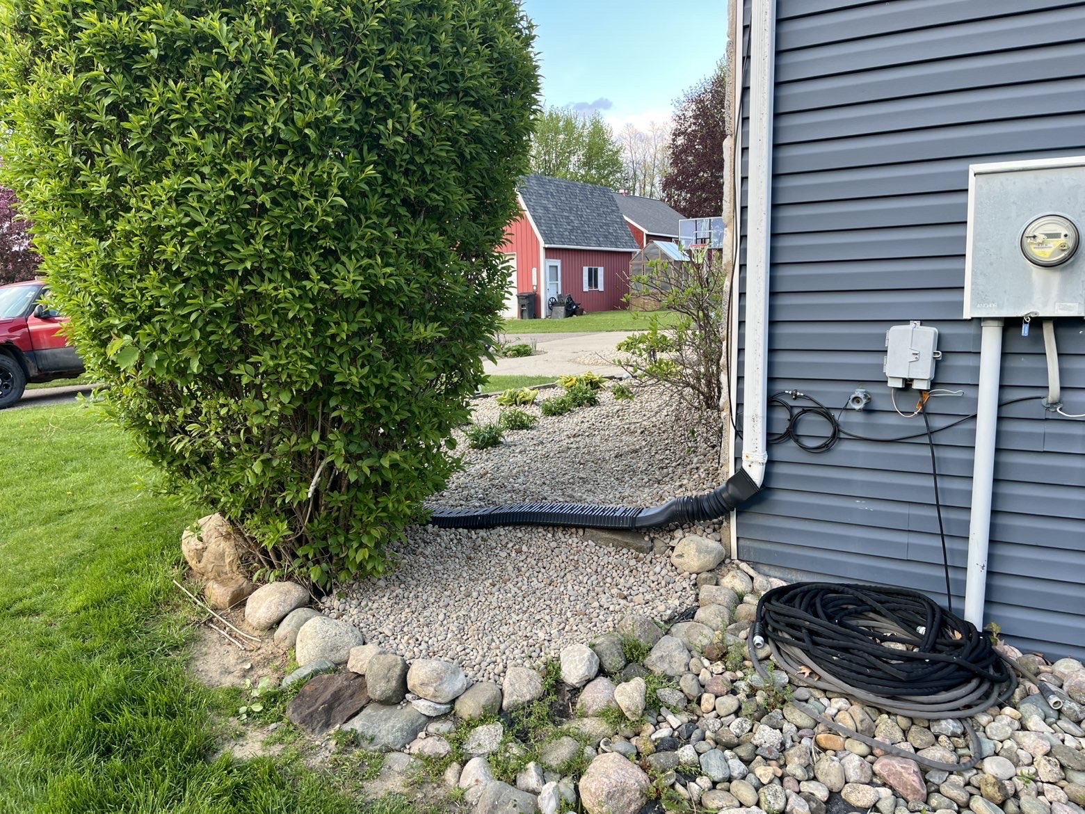 River rock drainage bed installed alongside the house